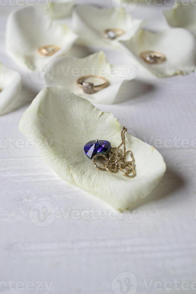 The necklace on white petal of rose. photo