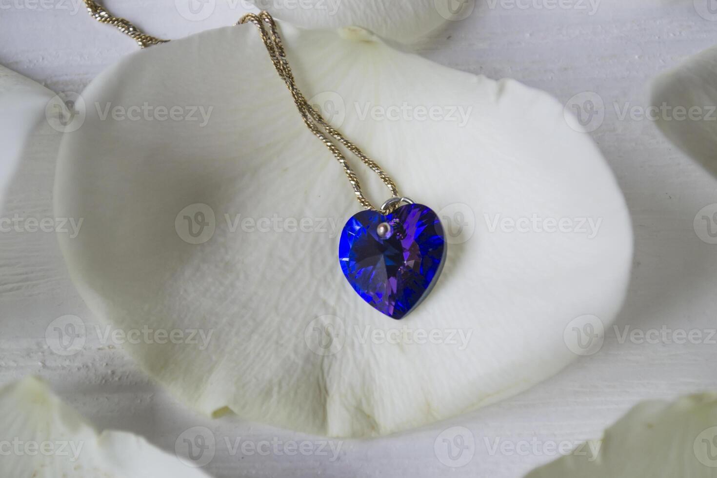 The necklace on white petal of rose. photo