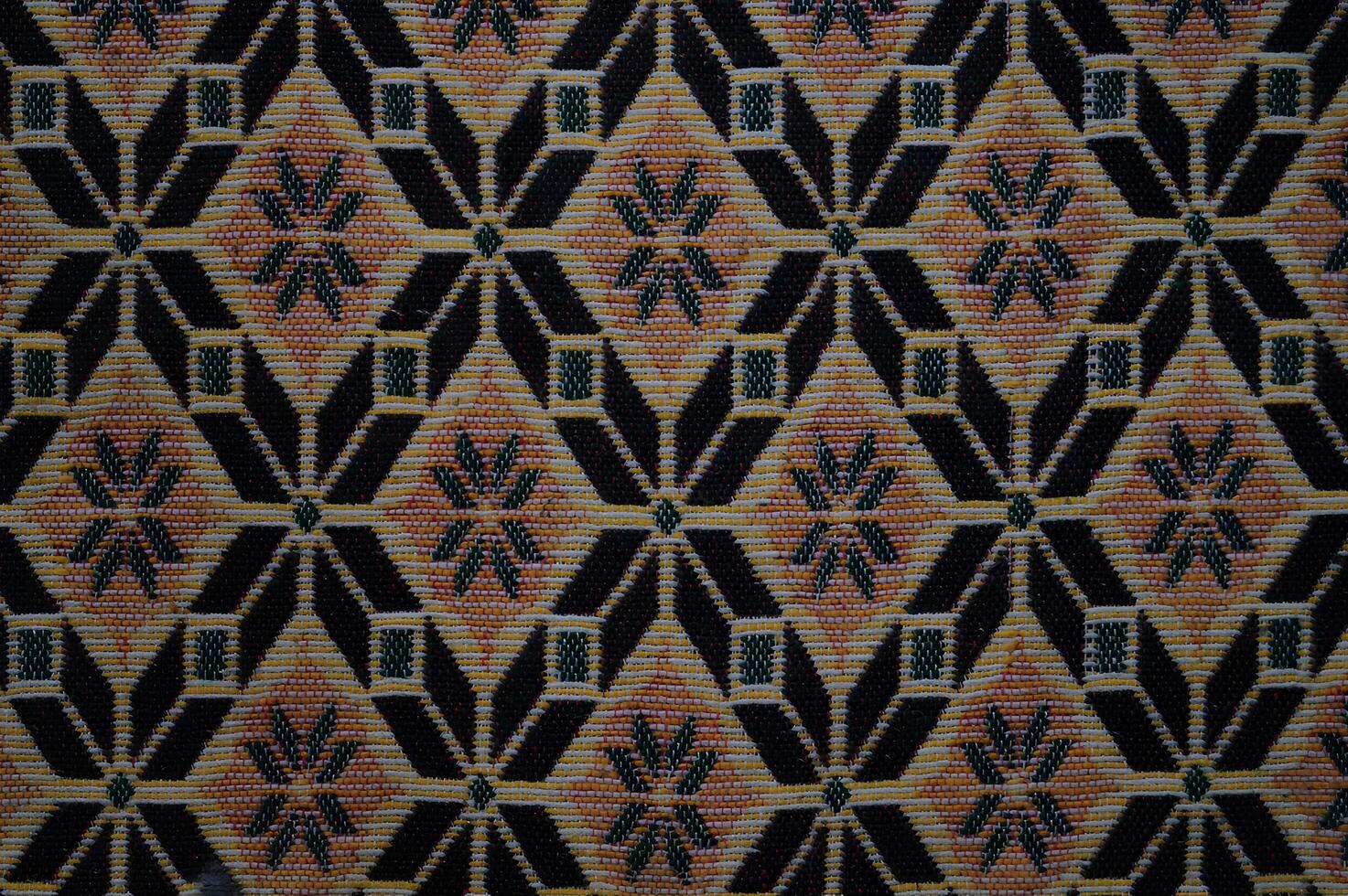 A patterned carpet with a black and brown color scheme photo