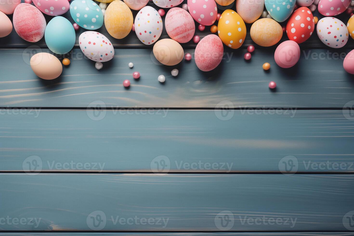 Easter holiday celebration banner greeting card banner - frame made of painted easter eggs on blue wooden table texture, top view, flat lay photo