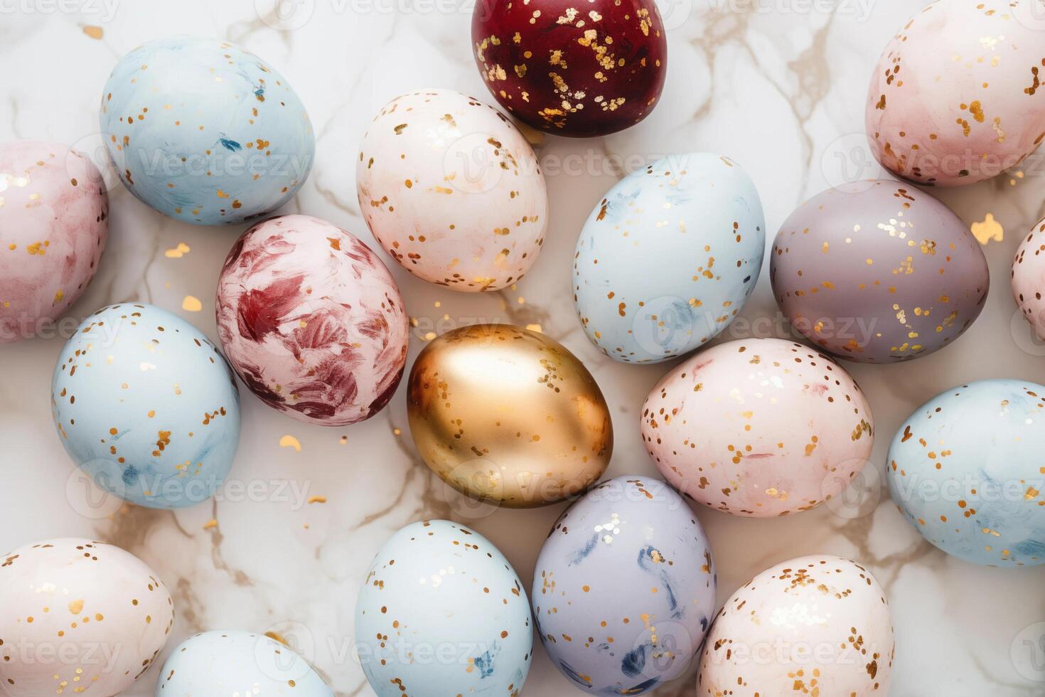 Pastel colored easter eggs speckled and painted with gold, top down view flatlay background photo