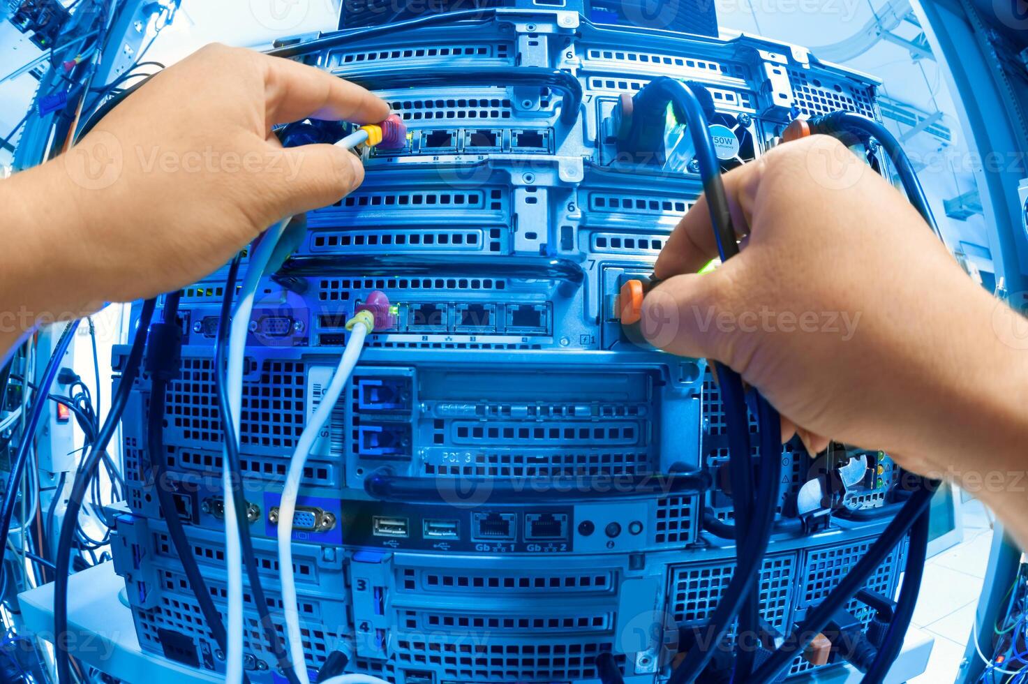 IT engineer repairing a server in a datacenter photo