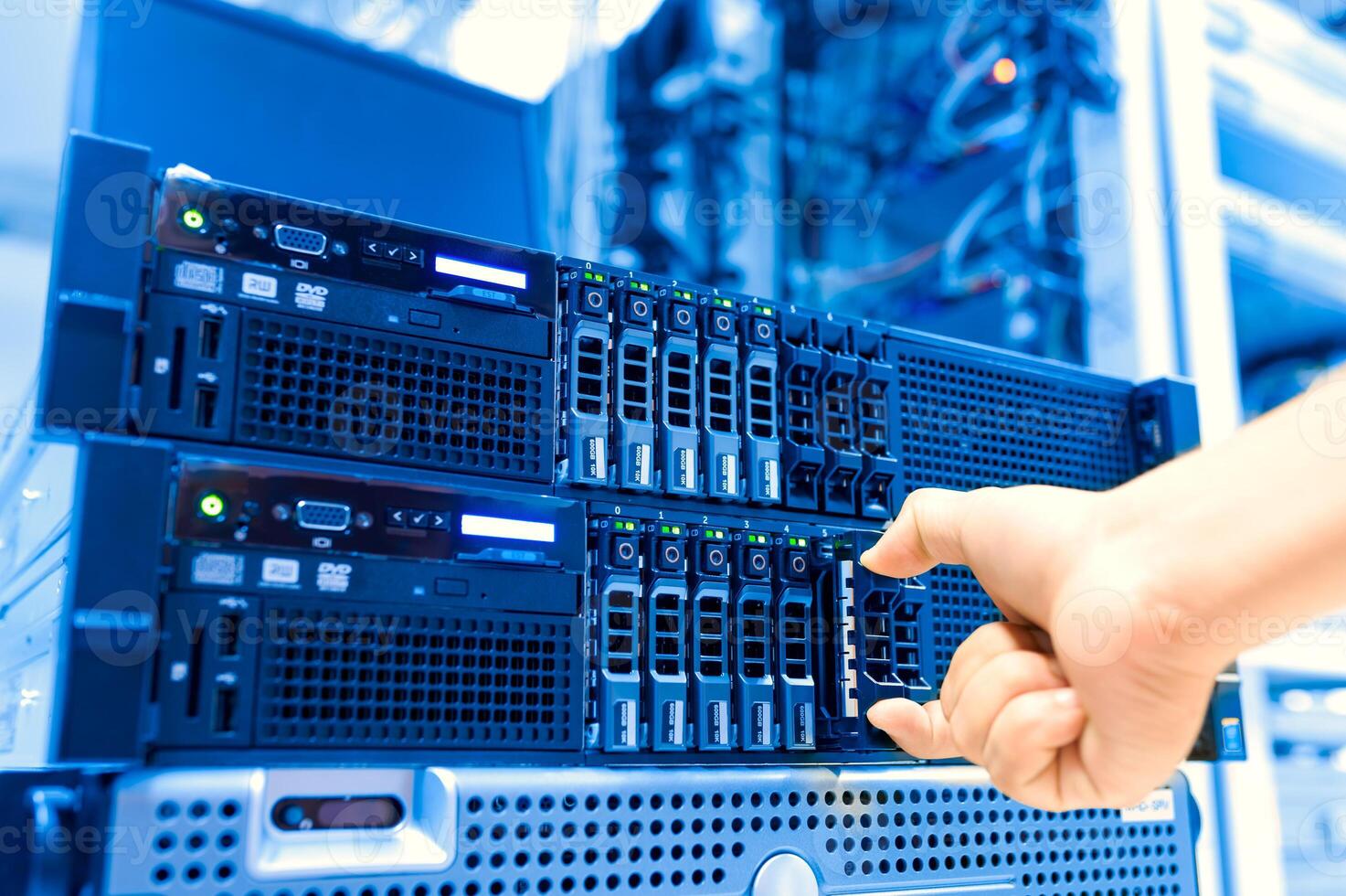 IT engineer repairing a server in a datacenter photo