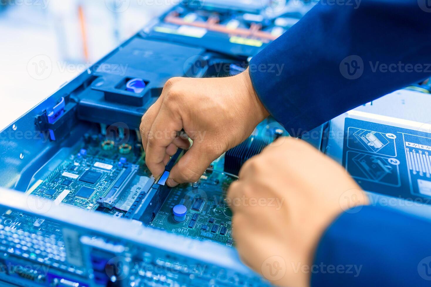 IT engineer repairing a server in a datacenter photo