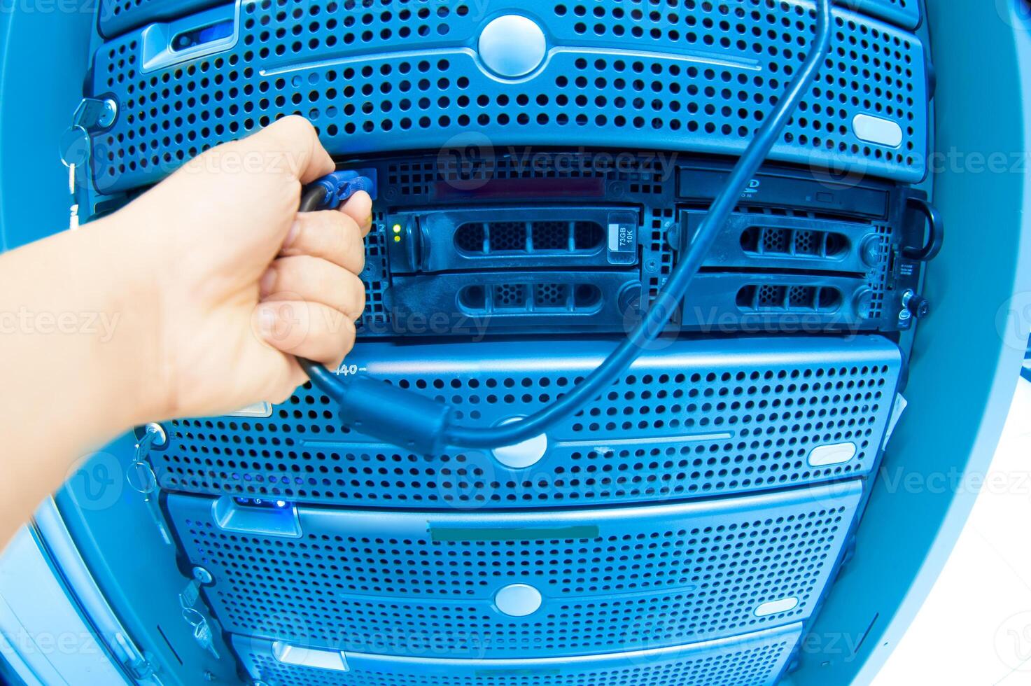 IT engineer repairing a server in a datacenter photo