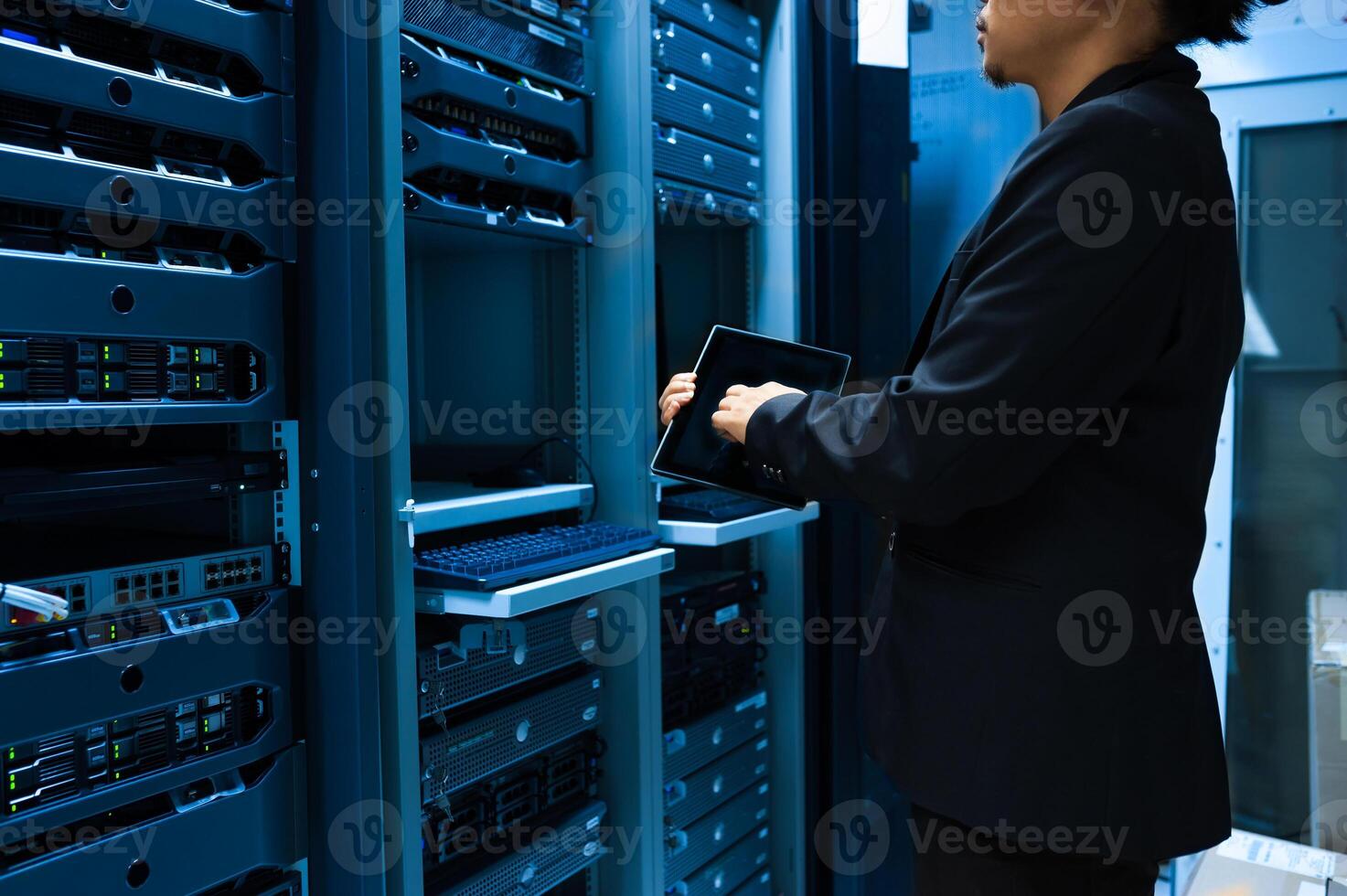 IT engineer repairing a server in a datacenter photo