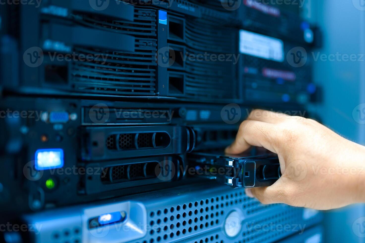 IT engineer repairing a server in a datacenter photo
