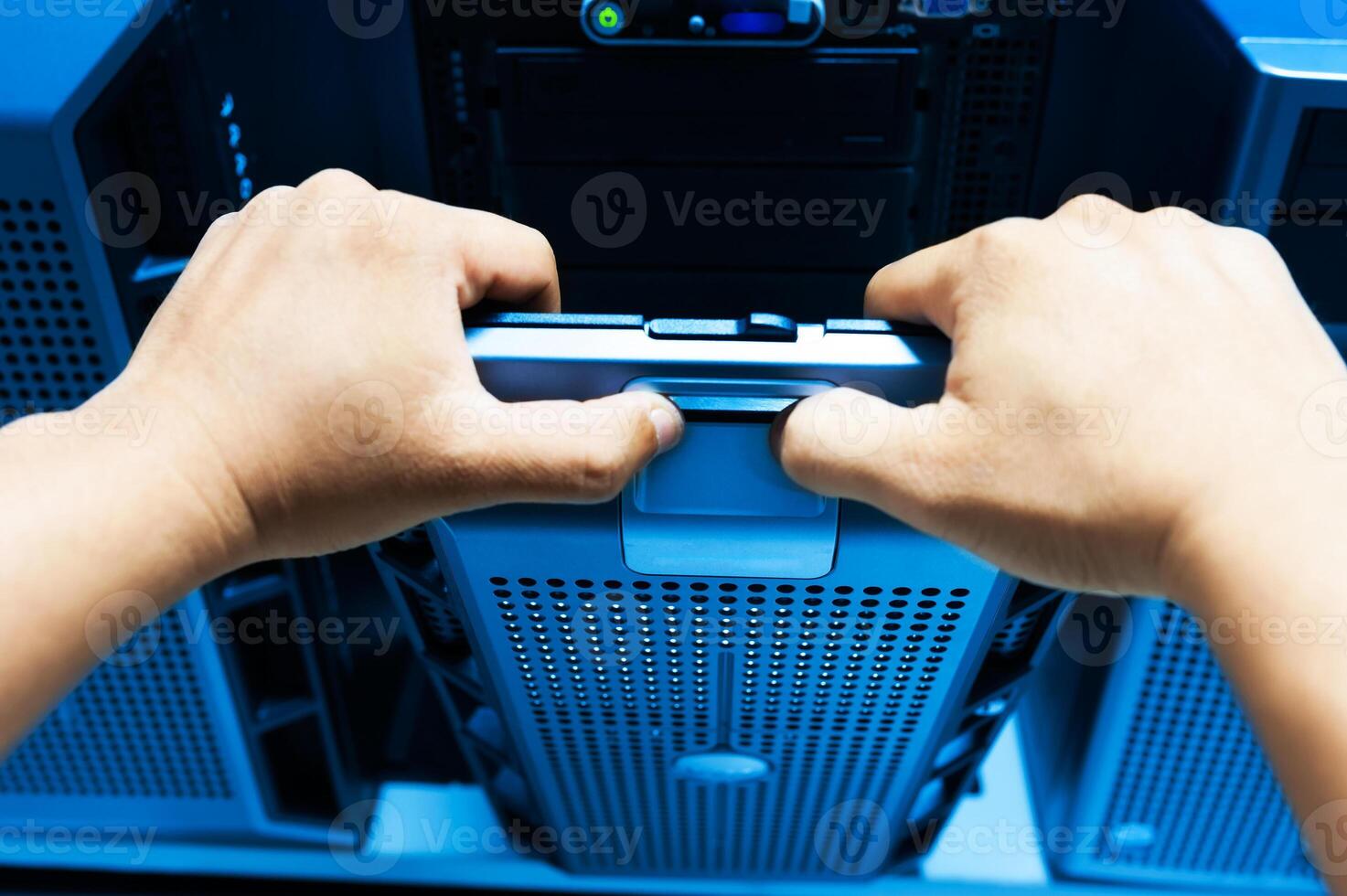 IT engineer repairing a server in a datacenter photo
