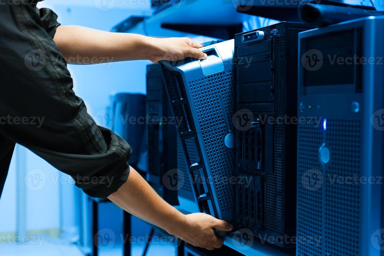 IT engineer repairing a server in a datacenter photo