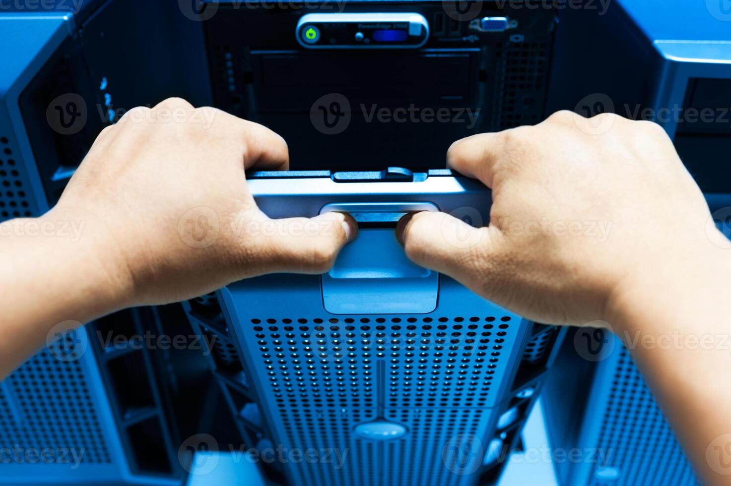 IT engineer repairing a server in a datacenter photo