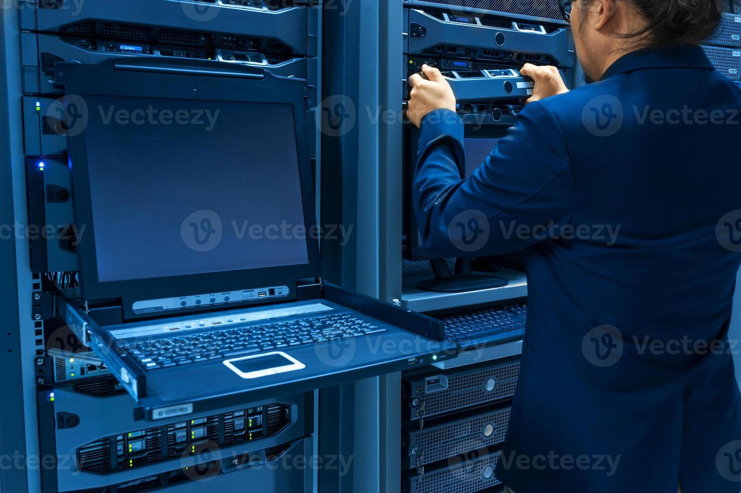 IT engineer repairing a server in a datacenter photo