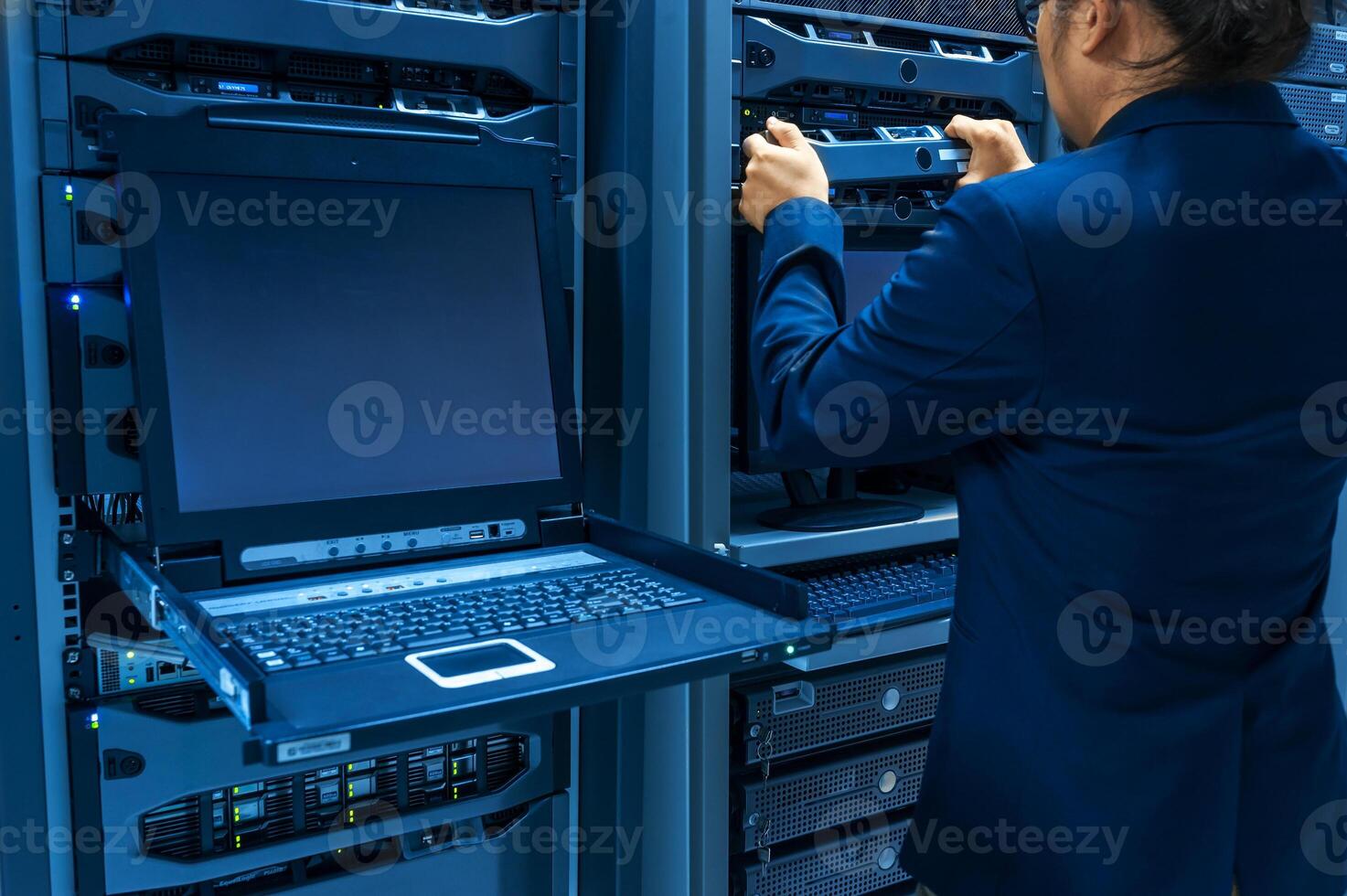 IT engineer repairing a server in a datacenter photo