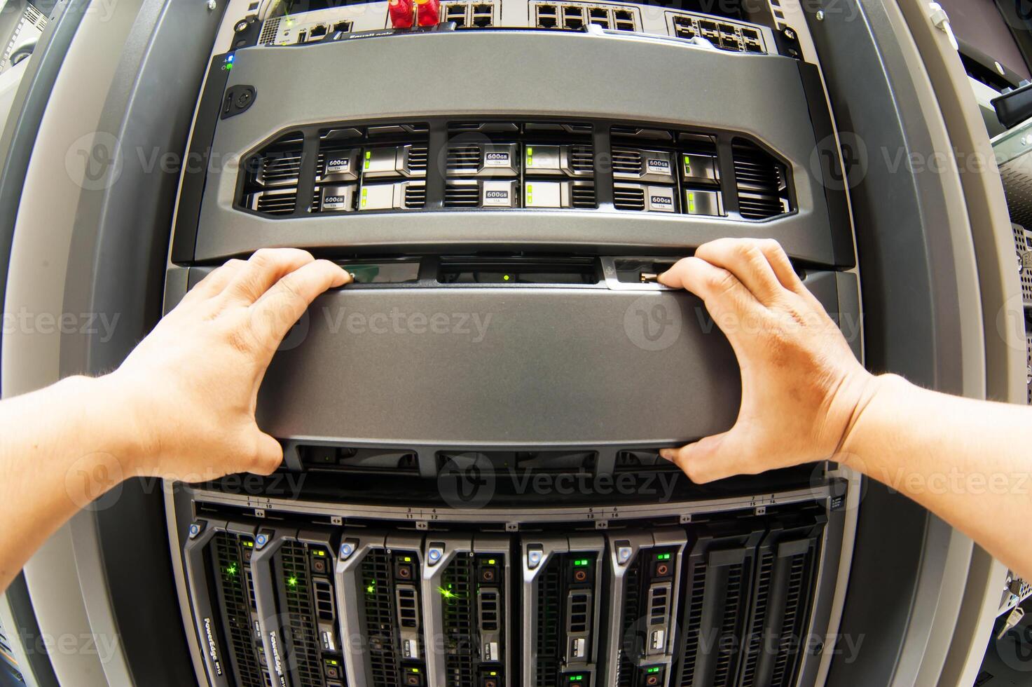 IT engineer repairing a server in a datacenter photo