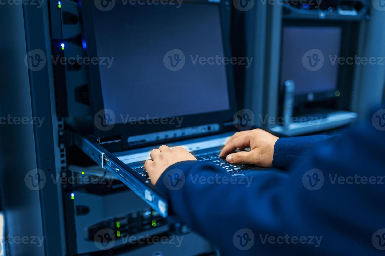 IT engineer repairing a server in a datacenter photo