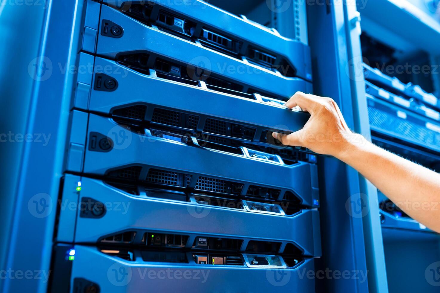 IT engineer repairing a server in a datacenter photo