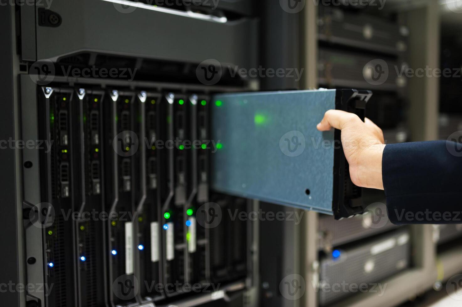 IT engineer repairing a server in a datacenter photo