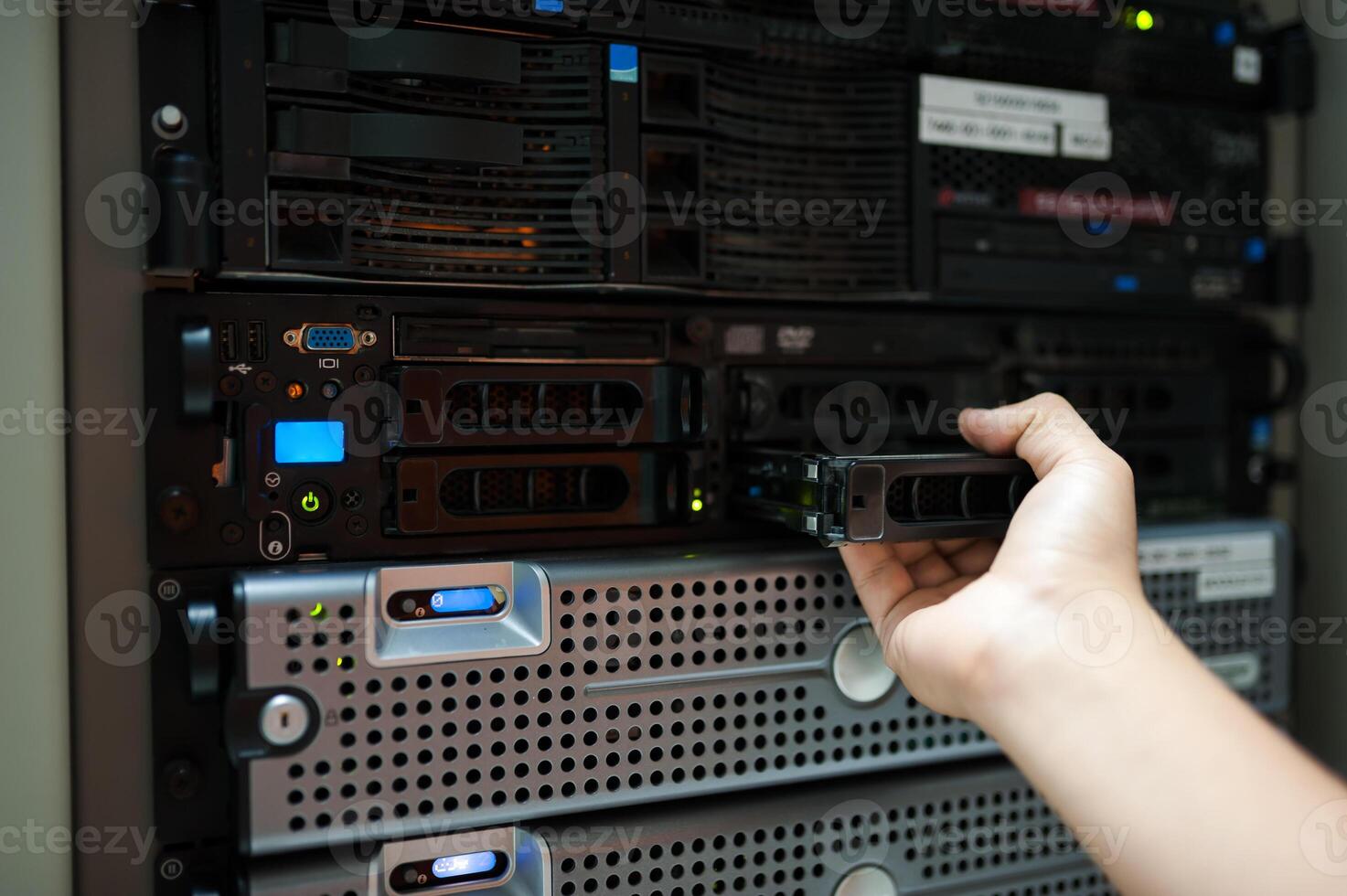 IT engineer repairing a server in a datacenter photo