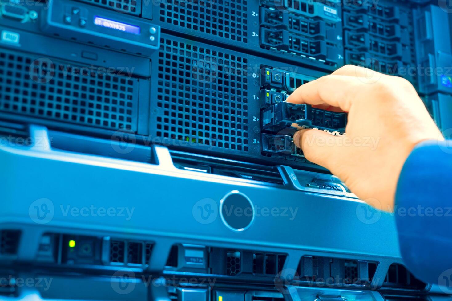 IT engineer repairing a server in a datacenter photo