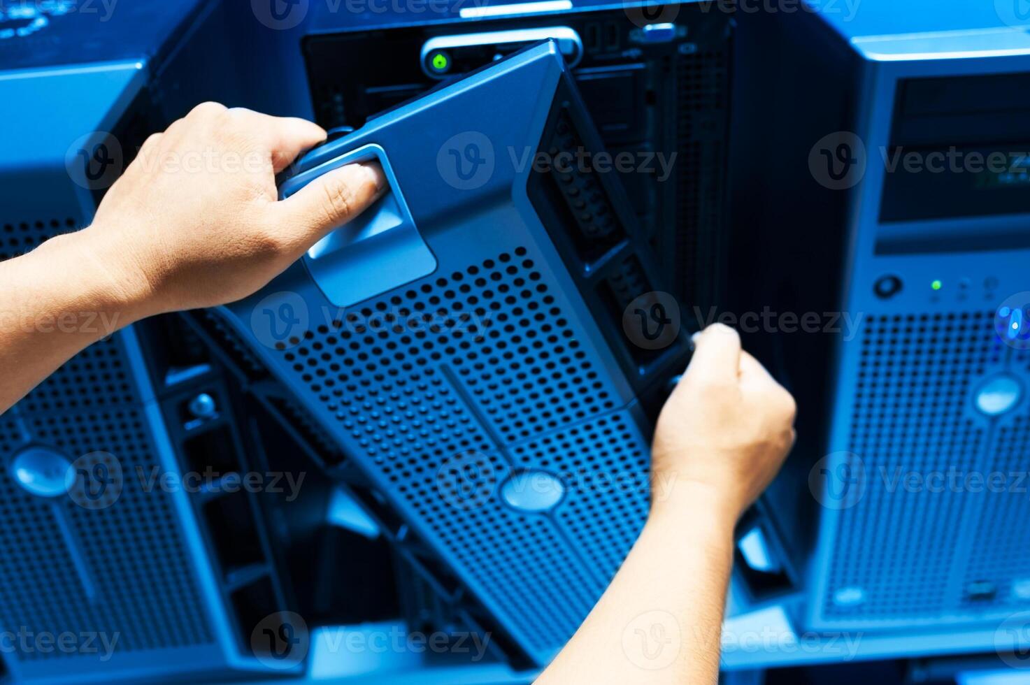 IT engineer repairing a server in a datacenter photo