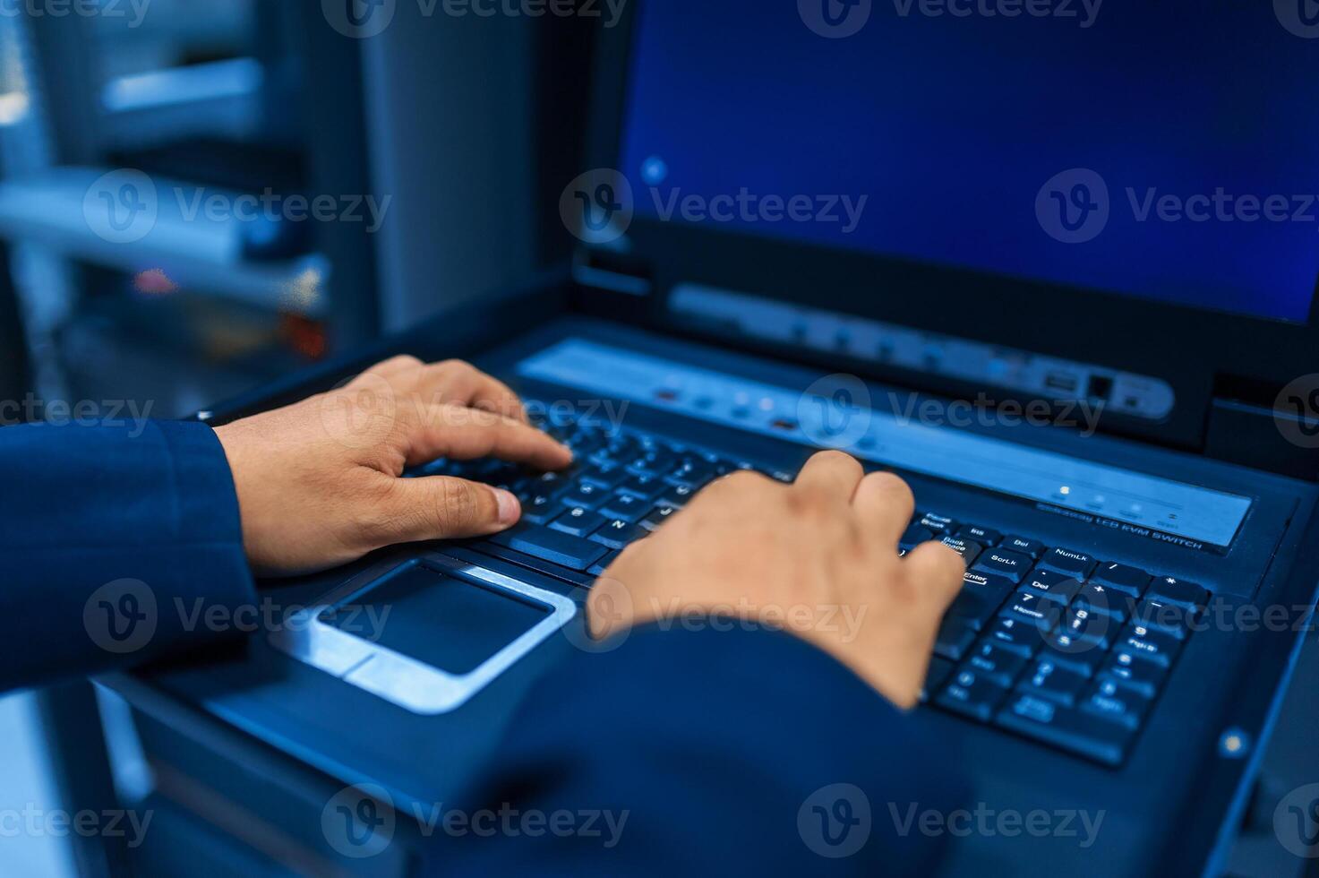 IT engineer repairing a server in a datacenter photo