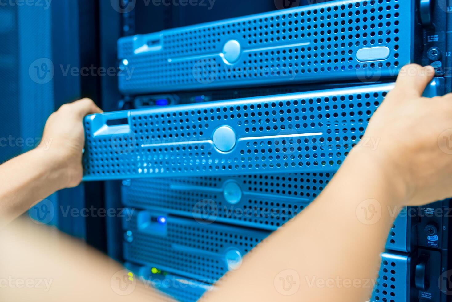 IT engineer repairing a server in a datacenter photo