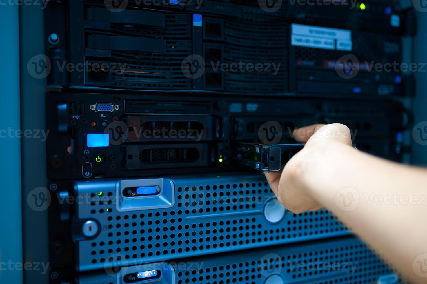 IT engineer repairing a server in a datacenter photo