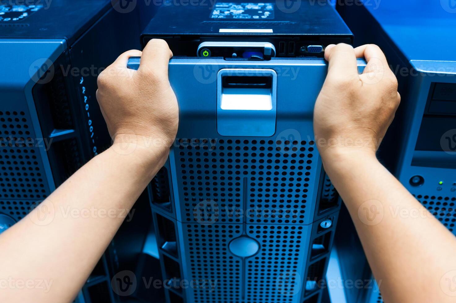 IT engineer repairing a server in a datacenter photo