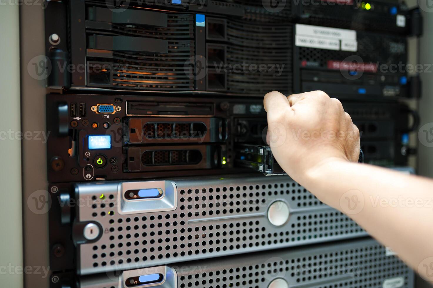 IT engineer repairing a server in a datacenter photo