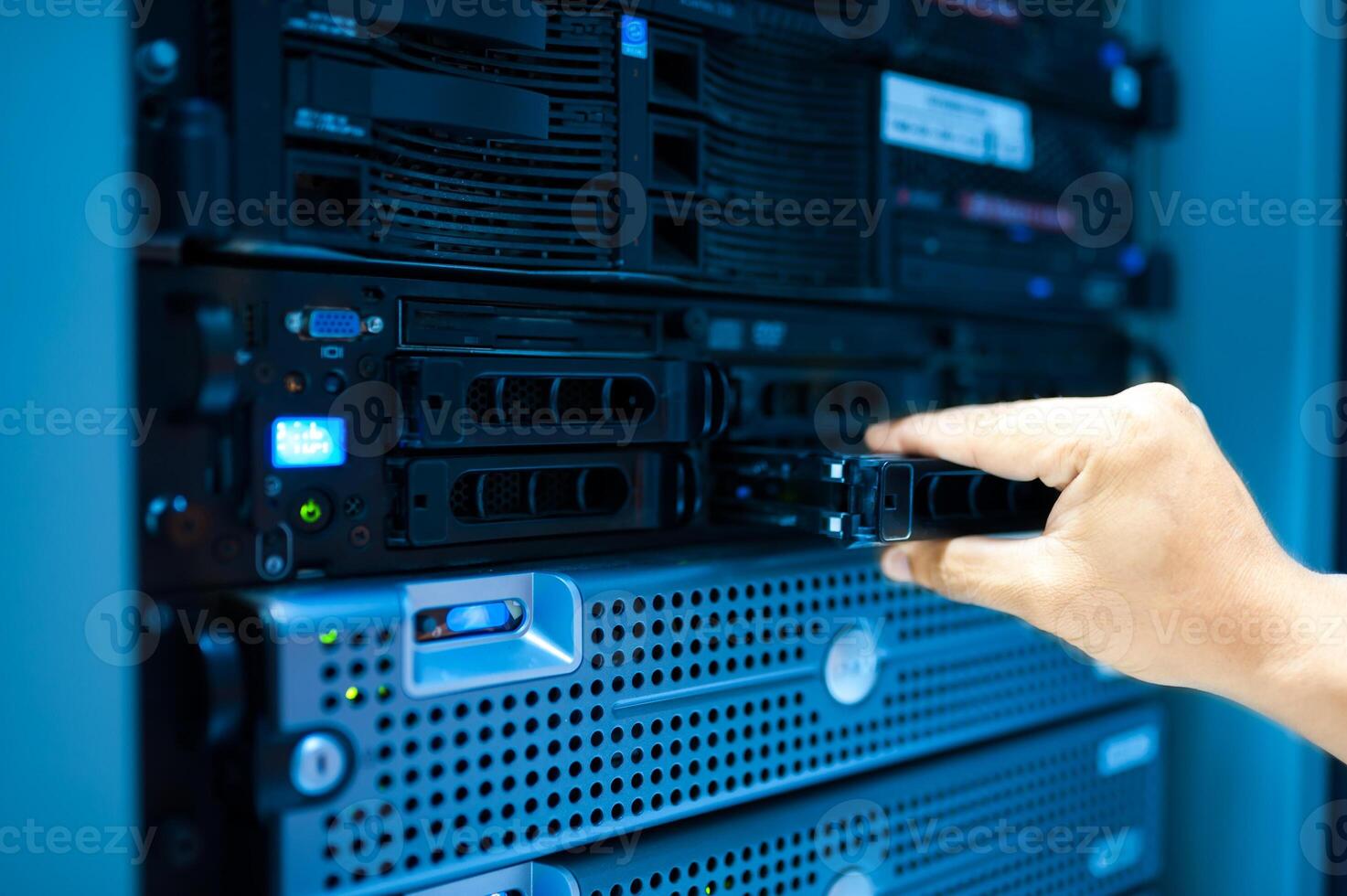 IT engineer repairing a server in a datacenter photo