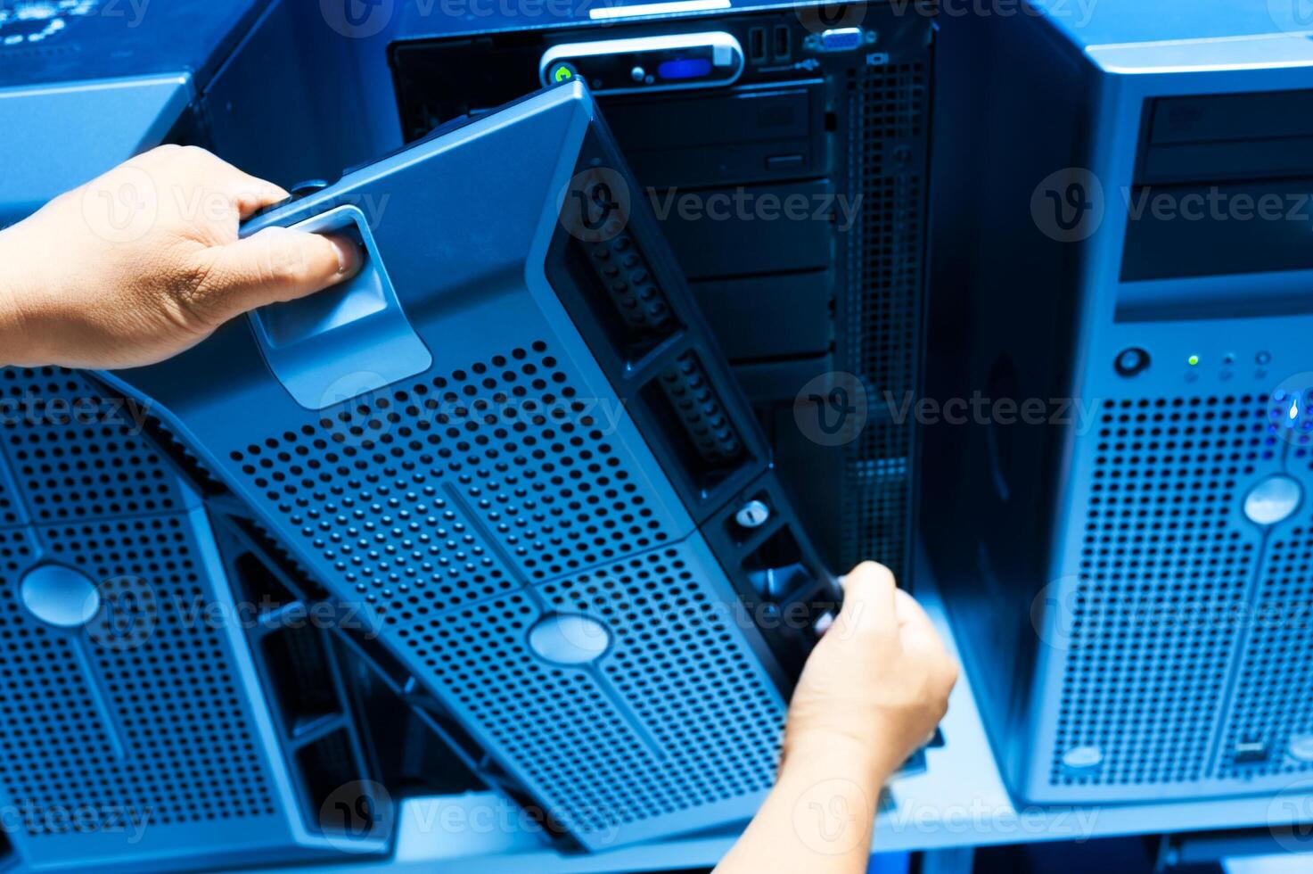 IT engineer repairing a server in a datacenter photo