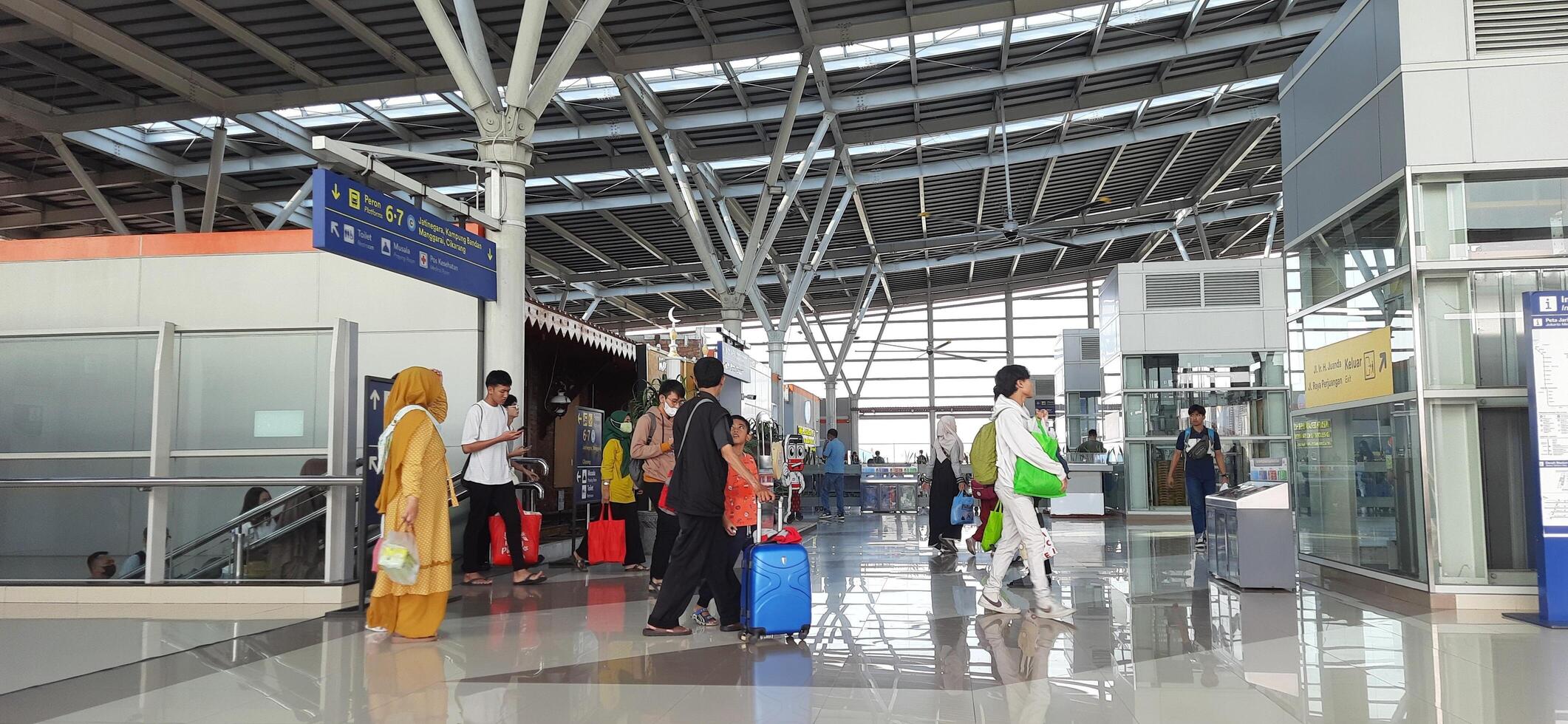 The atmosphere travelers or mudik lebaran or pulang kampung or idul fitri moments in train station Bekasi. West Java, Indonesia - April 8 2024 photo