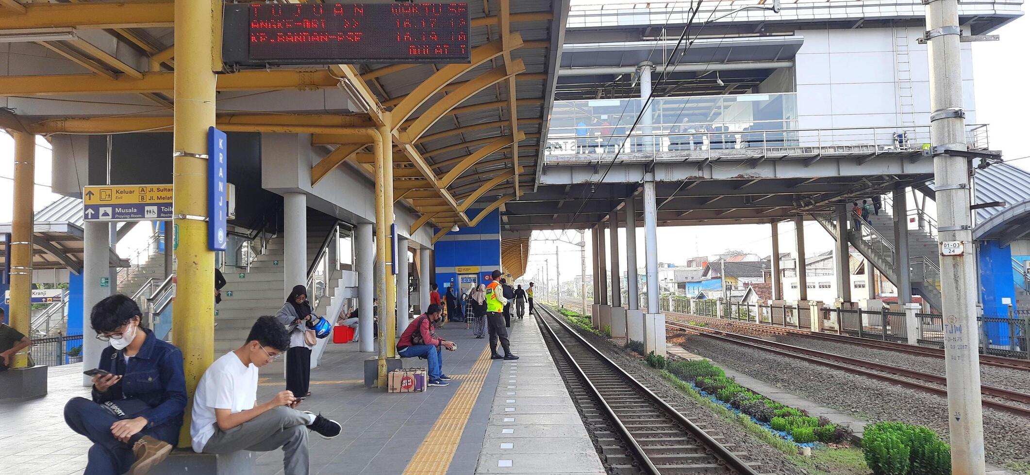 Activity people at railway train station Bekasi. Local train Indonesia. Railway road. West Java, Indonesia - April 8 2024 photo