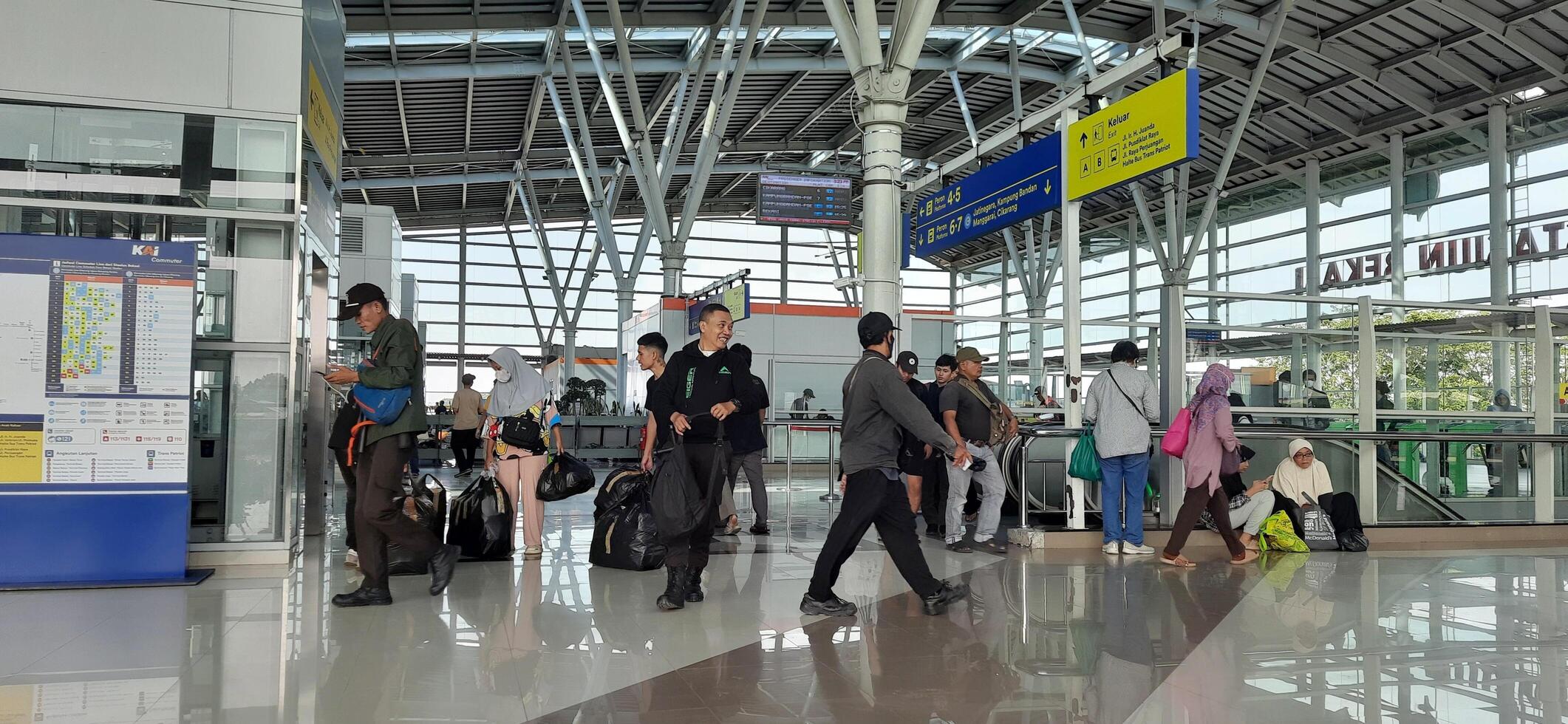 The atmosphere travelers or mudik lebaran or pulang kampung or idul fitri moments in train station Bekasi. West Java, Indonesia - April 8 2024 photo