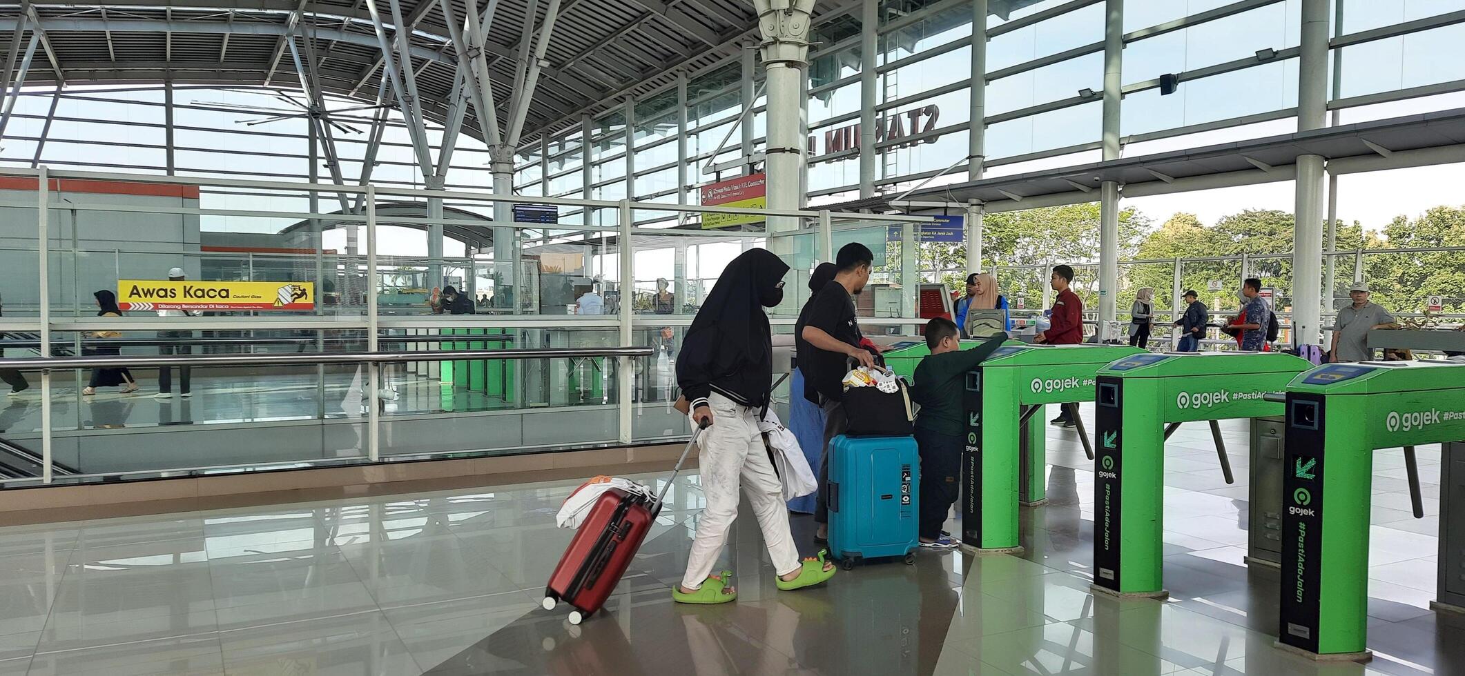 The atmosphere travelers or mudik lebaran or pulang kampung or idul fitri moments in train station Bekasi. West Java, Indonesia - April 8 2024 photo