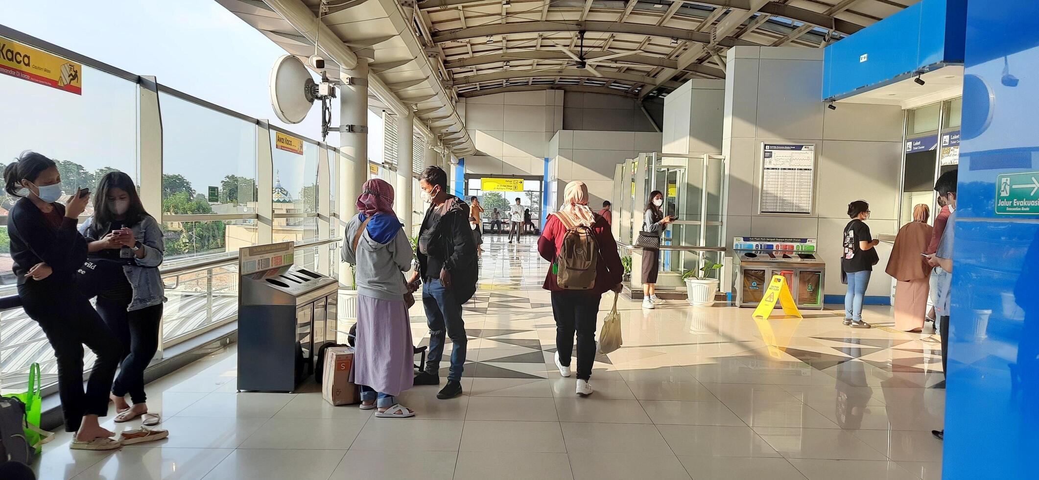 Activity people at railway train station Bekasi. Local train Indonesia. Railway road. West Java, Indonesia - April 8 2024 photo
