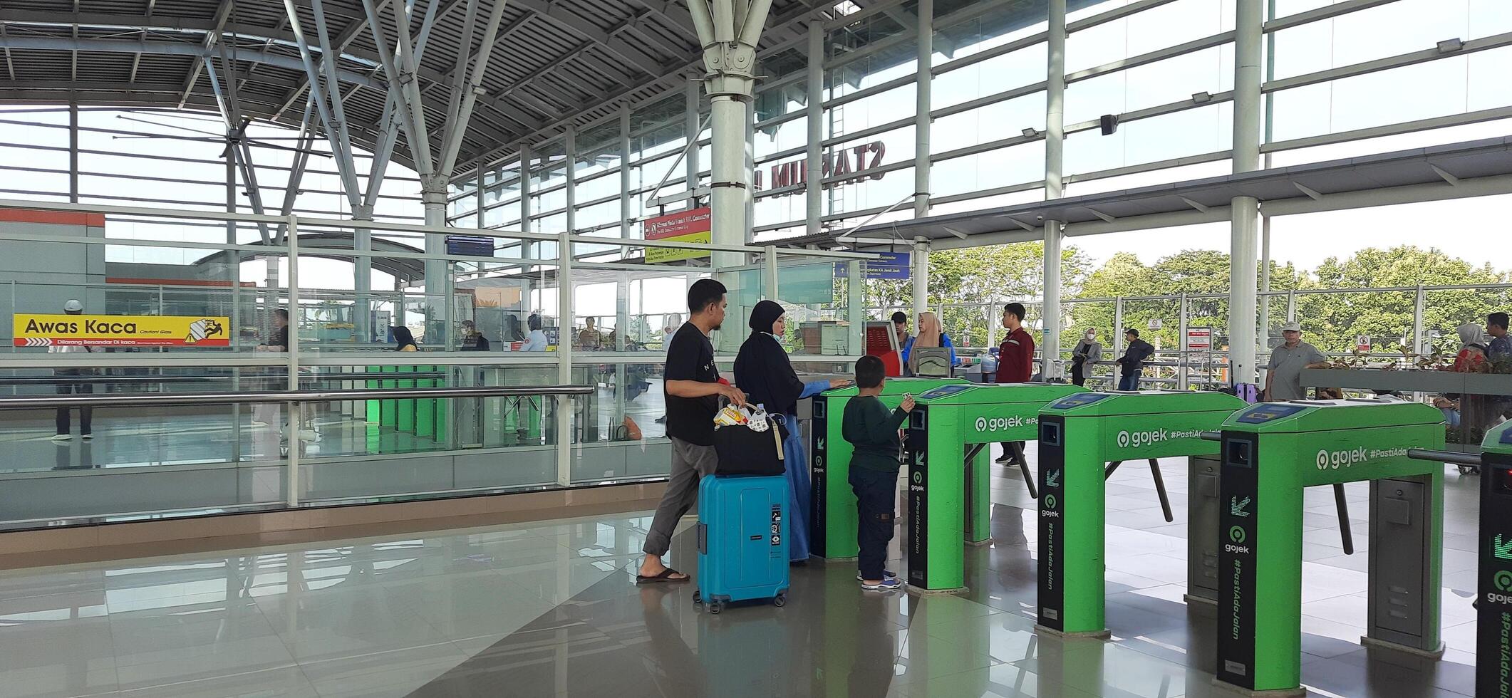 The atmosphere travelers or mudik lebaran or pulang kampung or idul fitri moments in train station Bekasi. West Java, Indonesia - April 8 2024 photo