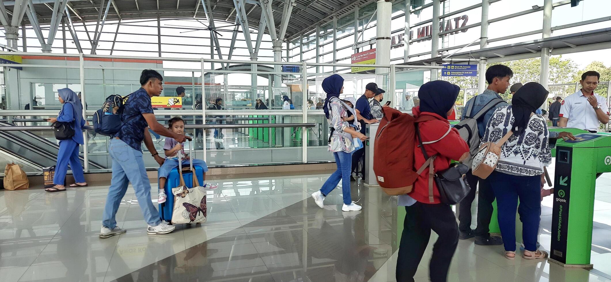 The atmosphere travelers or mudik lebaran or pulang kampung or idul fitri moments in train station Bekasi. West Java, Indonesia - April 8 2024 photo