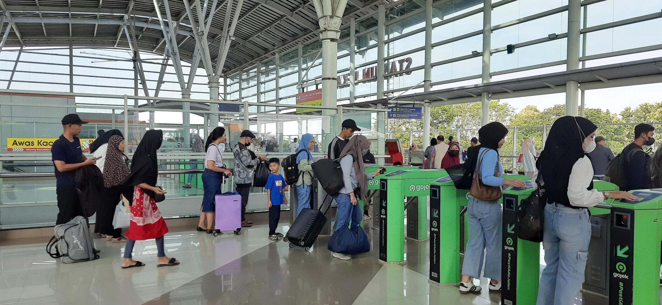 The atmosphere travelers or mudik lebaran or pulang kampung or idul fitri moments in train station Bekasi. West Java, Indonesia - April 8 2024 photo
