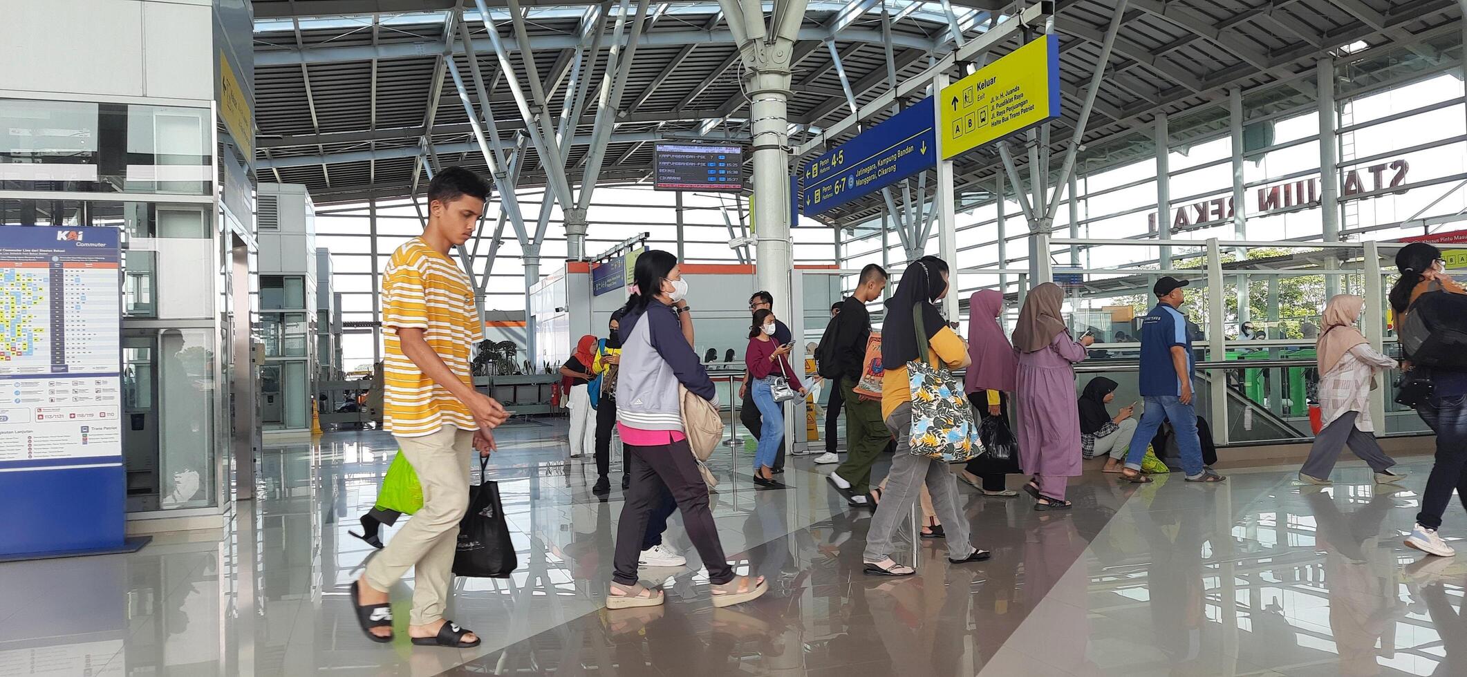 The atmosphere travelers or mudik lebaran or pulang kampung or idul fitri moments in train station Bekasi. West Java, Indonesia - April 8 2024 photo