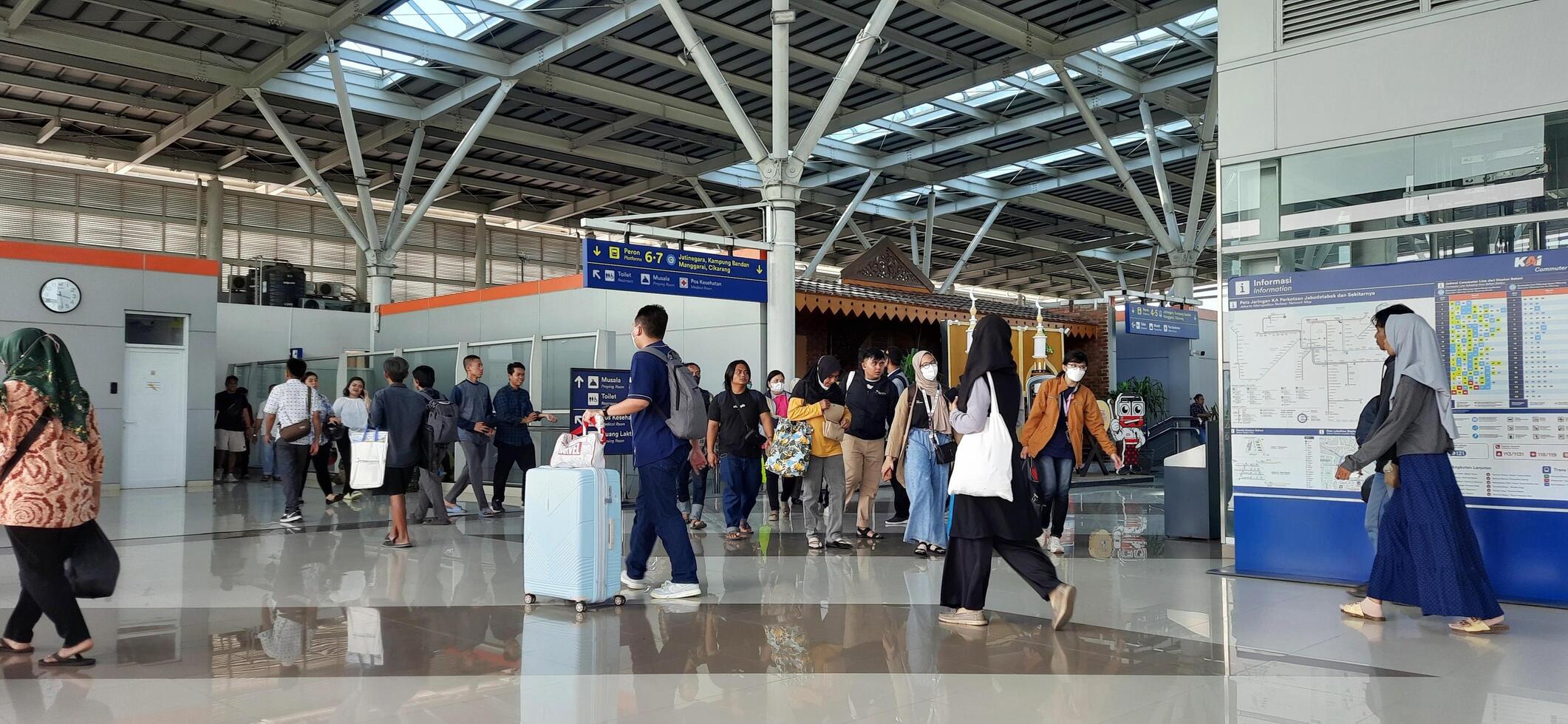 The atmosphere travelers or mudik lebaran or pulang kampung or idul fitri moments in train station Bekasi. West Java, Indonesia - April 8 2024 photo