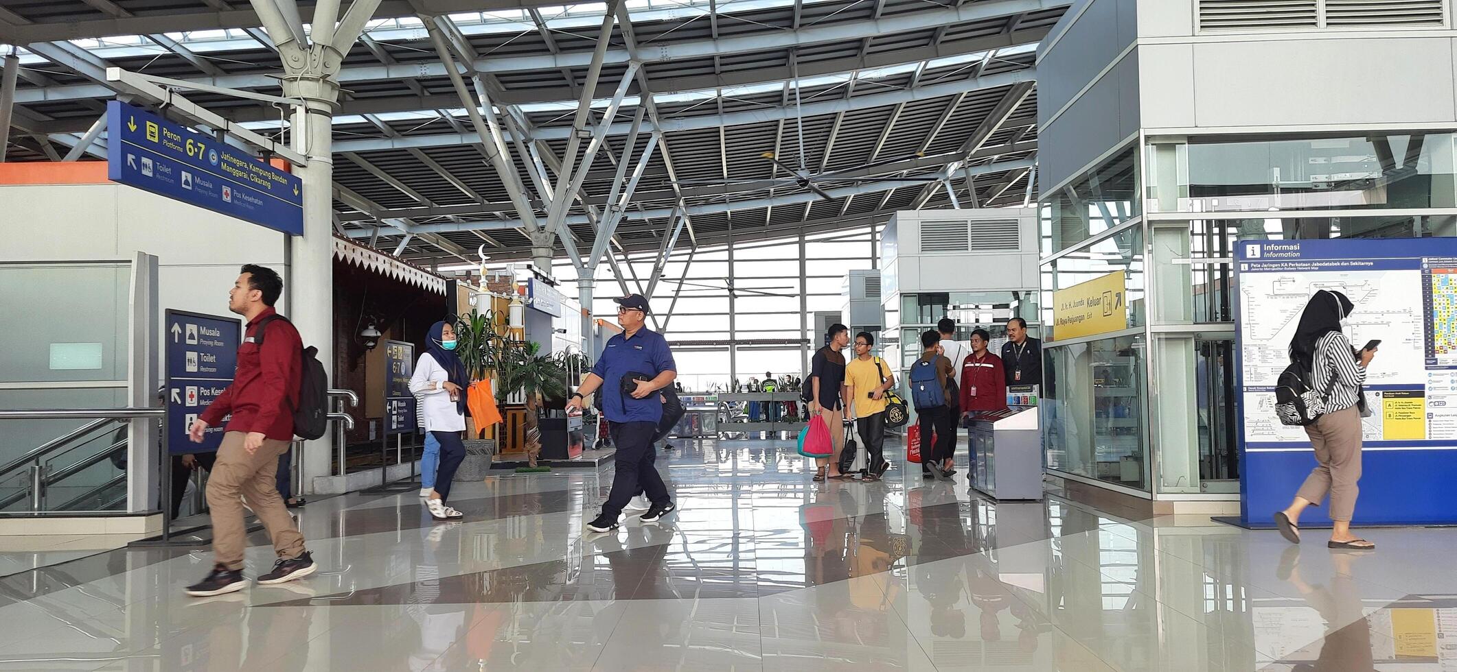 The atmosphere travelers or mudik lebaran or pulang kampung or idul fitri moments in train station Bekasi. West Java, Indonesia - April 8 2024 photo