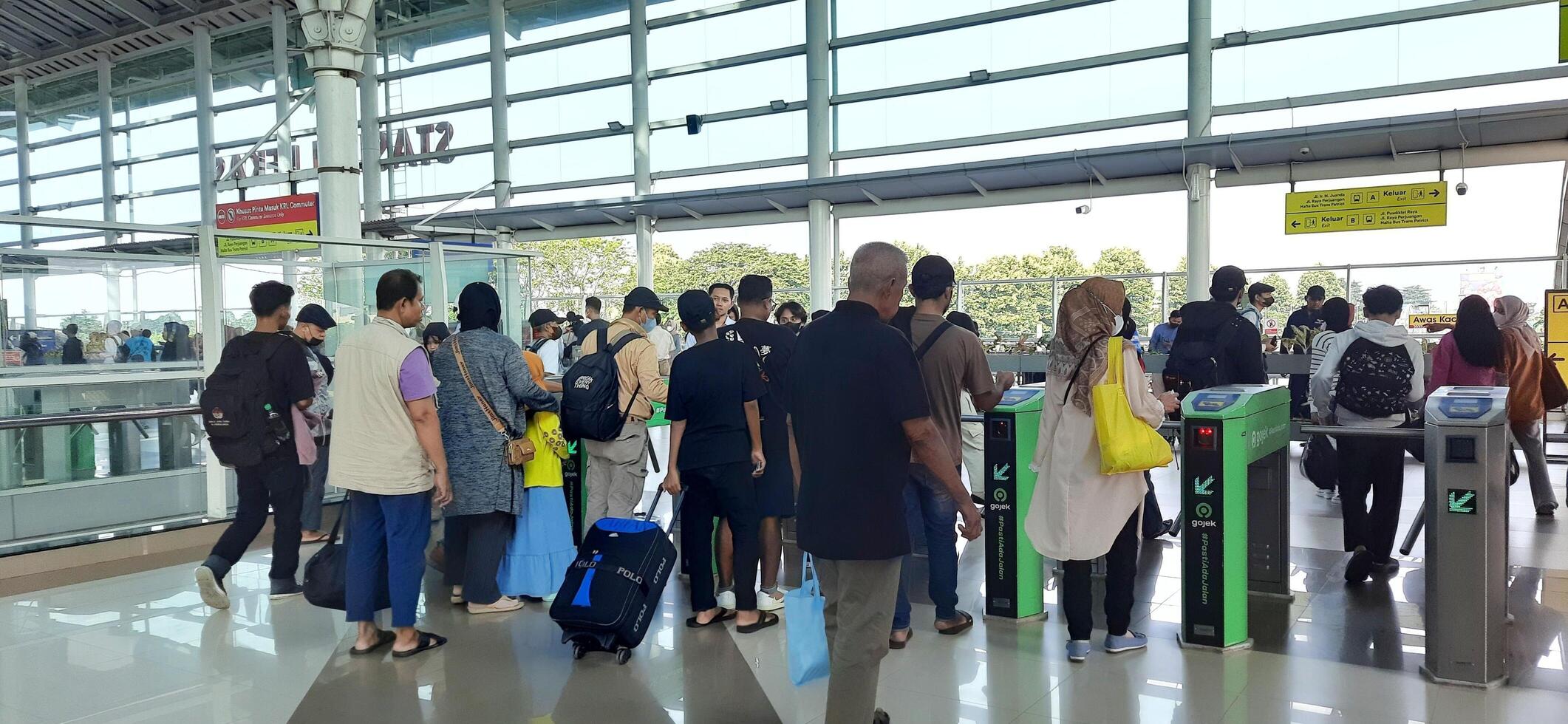 The atmosphere travelers or mudik lebaran or pulang kampung or idul fitri moments in train station Bekasi. West Java, Indonesia - April 8 2024 photo