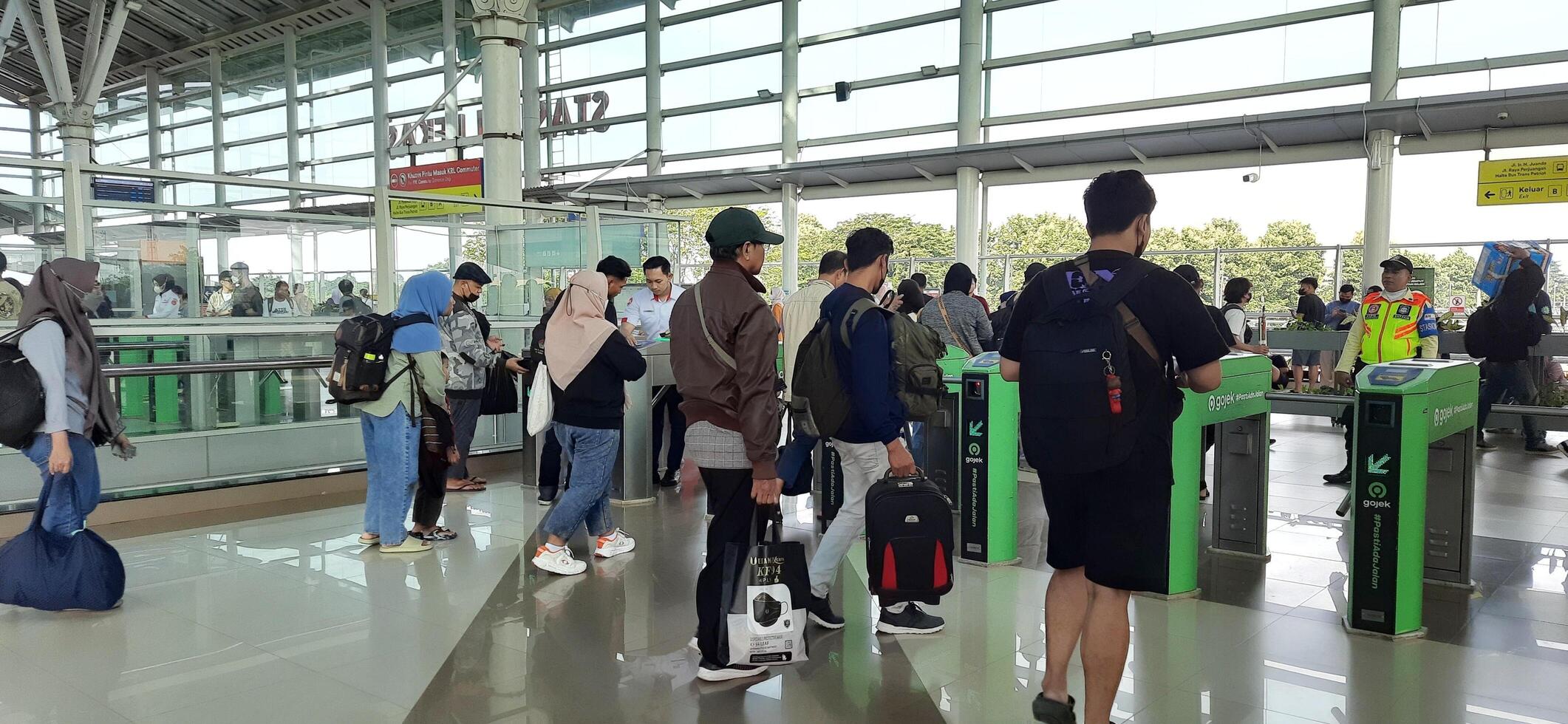 The atmosphere travelers or mudik lebaran or pulang kampung or idul fitri moments in train station Bekasi. West Java, Indonesia - April 8 2024 photo