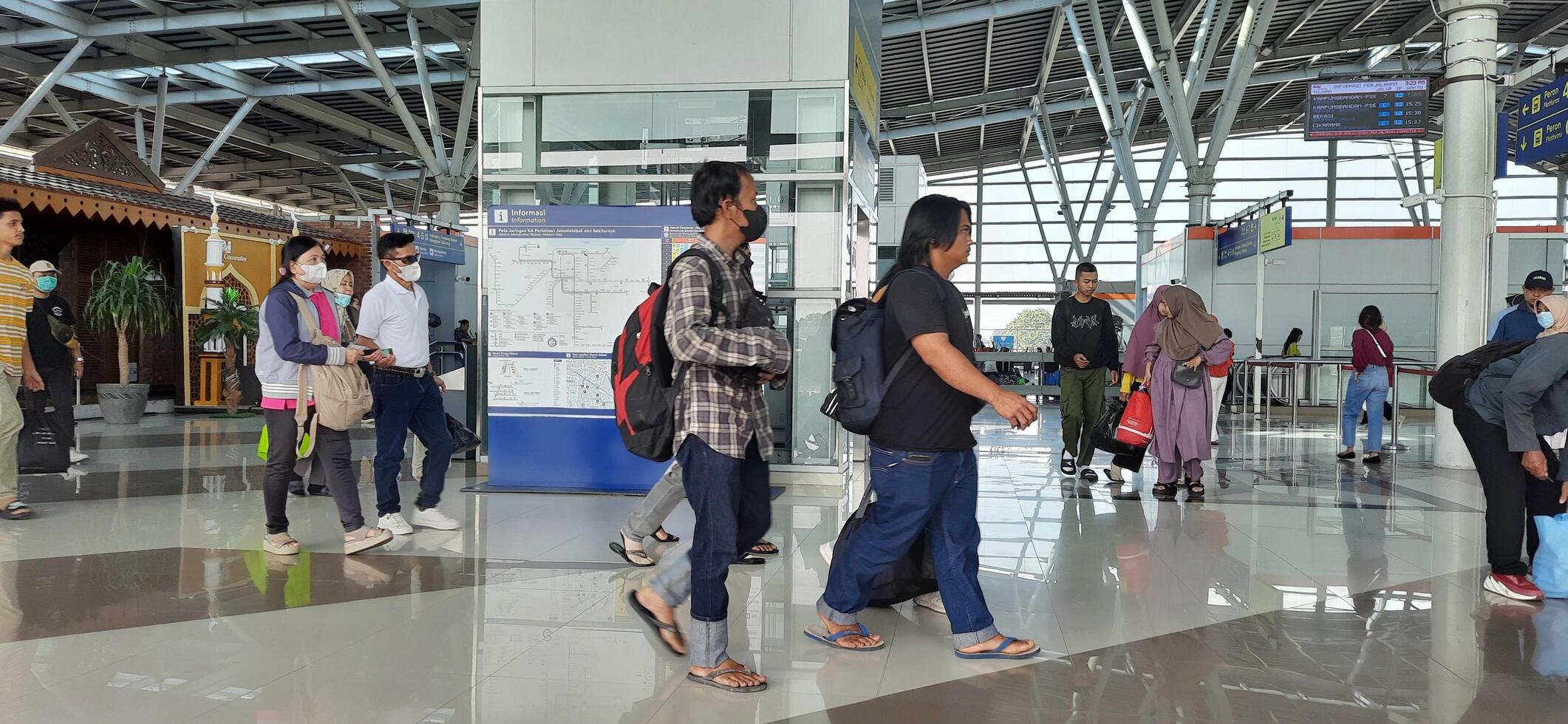 The atmosphere travelers or mudik lebaran or pulang kampung or idul fitri moments in train station Bekasi. West Java, Indonesia - April 8 2024 photo