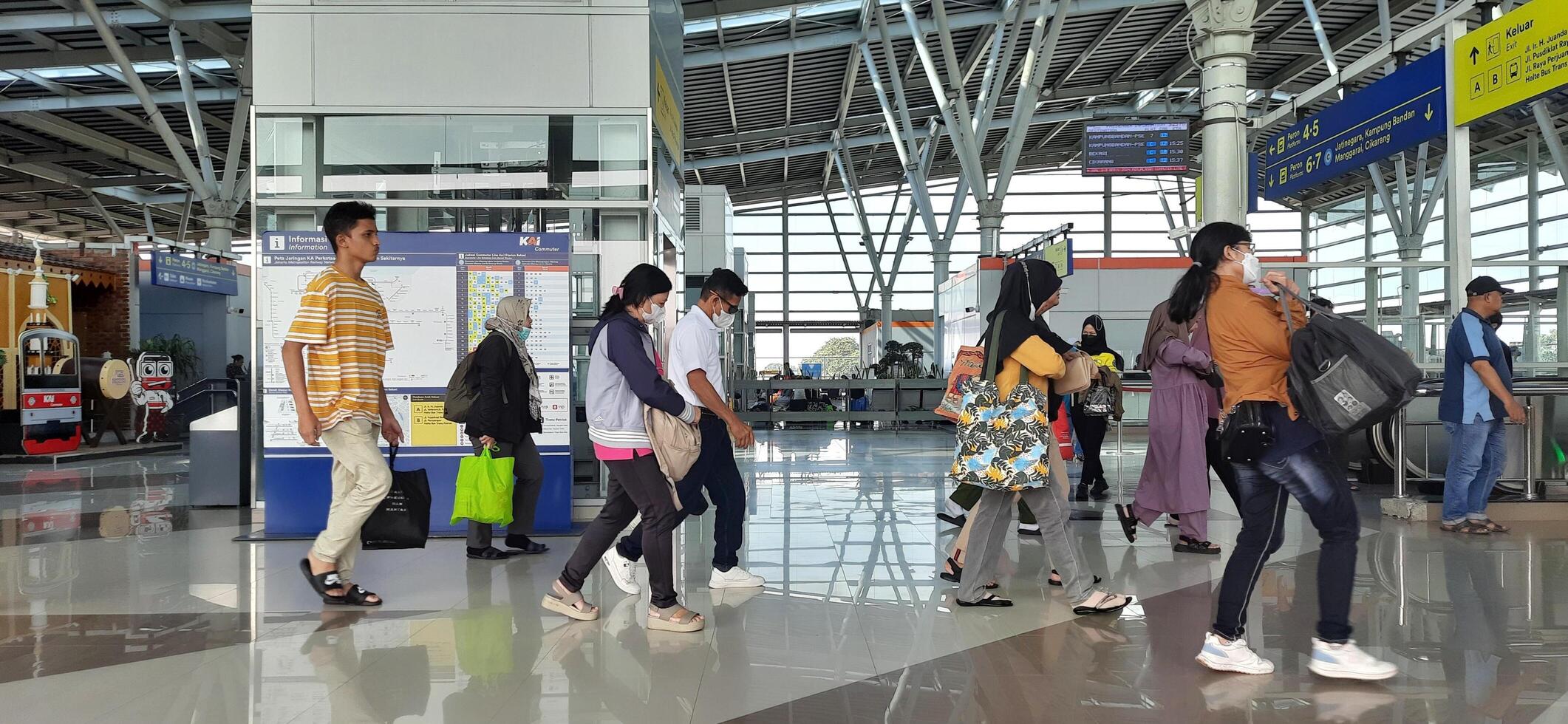 The atmosphere travelers or mudik lebaran or pulang kampung or idul fitri moments in train station Bekasi. West Java, Indonesia - April 8 2024 photo