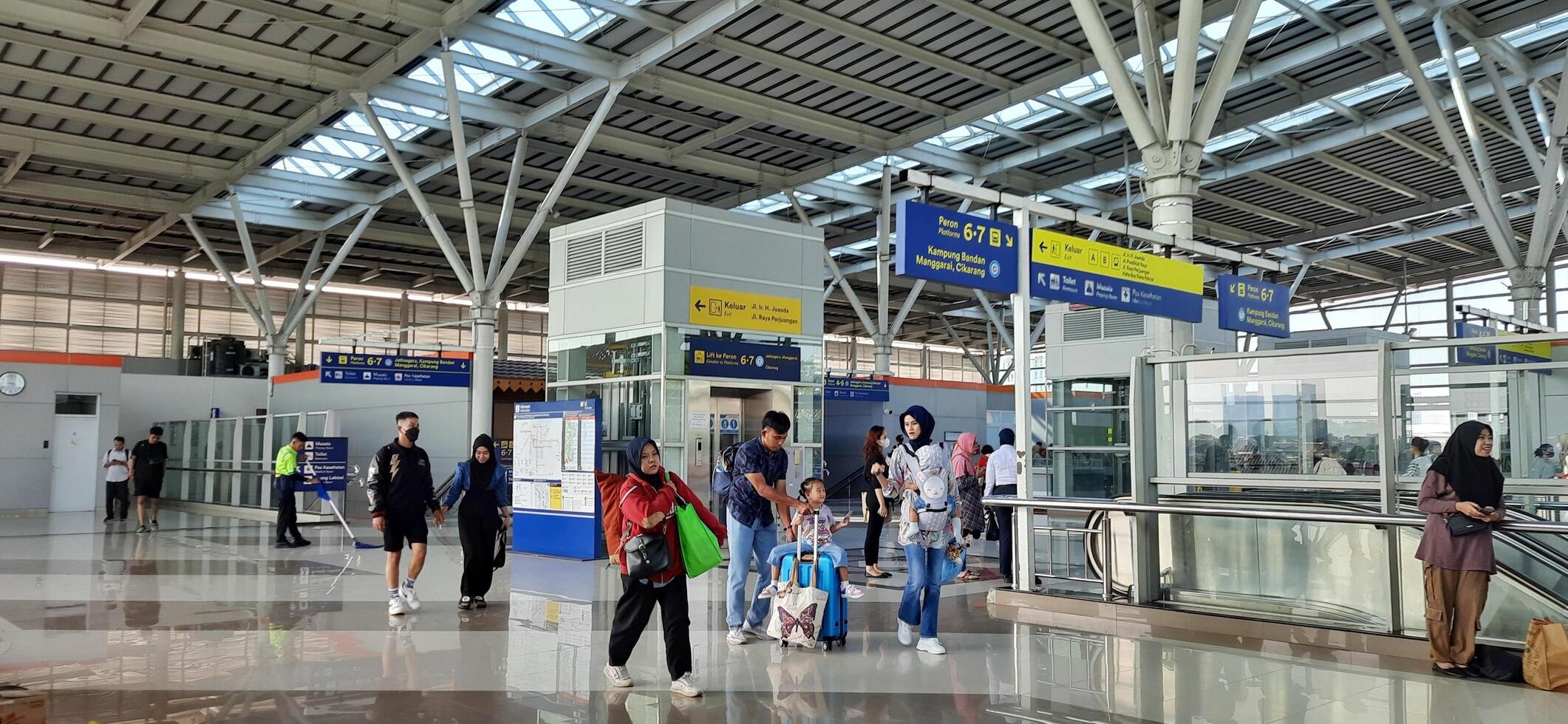 The atmosphere travelers or mudik lebaran or pulang kampung or idul fitri moments in train station Bekasi. West Java, Indonesia - April 8 2024 photo