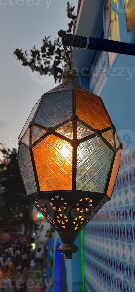 Beautiful Arabian Turkish hanging light. Lantern lamp night decoration exterior background photo