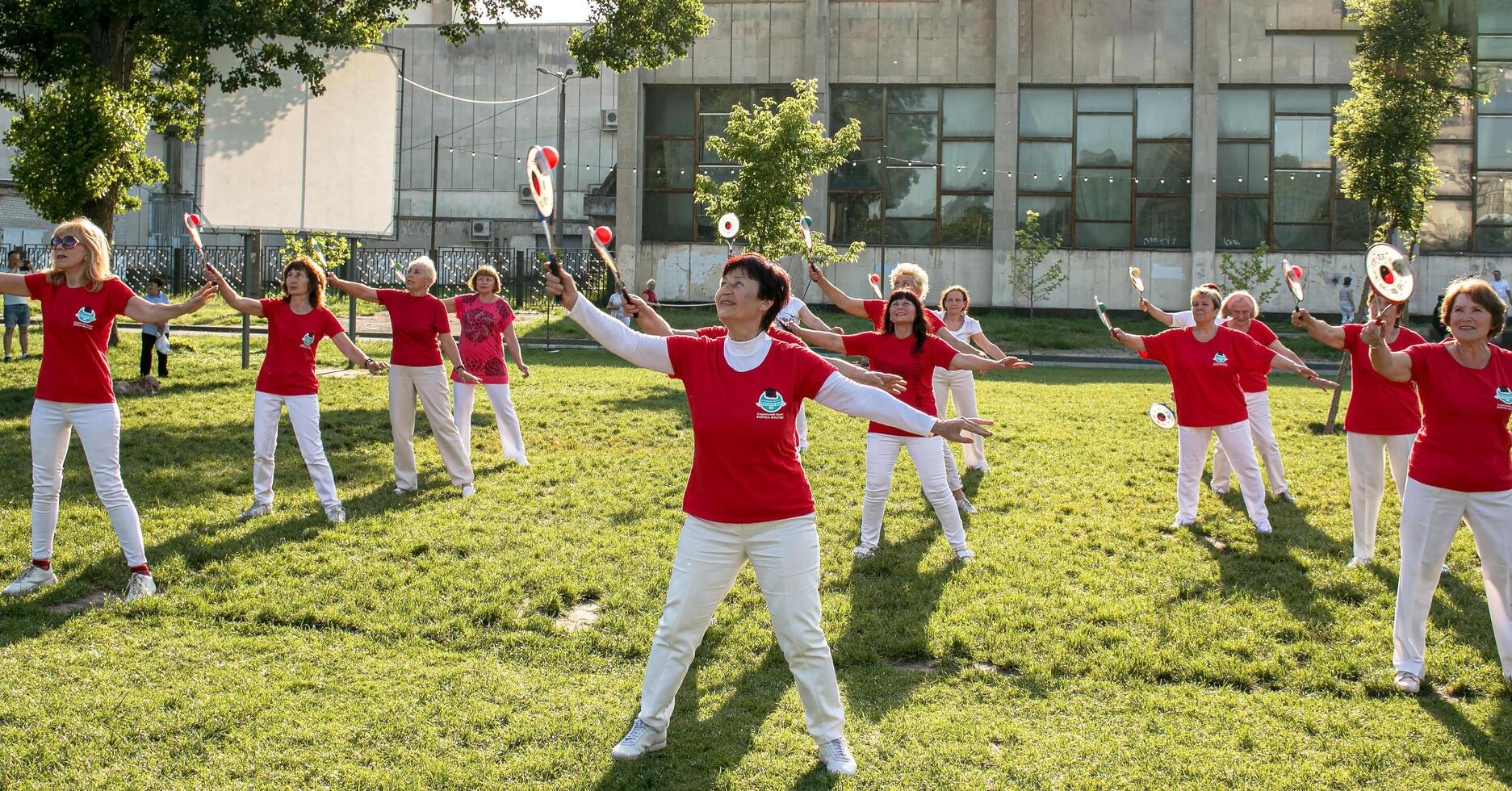 Dnepr, Ukraine - 06.21.2021 Group of elderly people doing health and fitness gymnastics in the park. photo