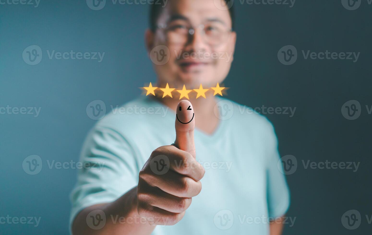 Man in good mood, smiling thinking positive hand thumb up with pop up five star and emotion smiley face icon for feedback review. Customer experience satisfaction Best Excellent Services Rating. photo