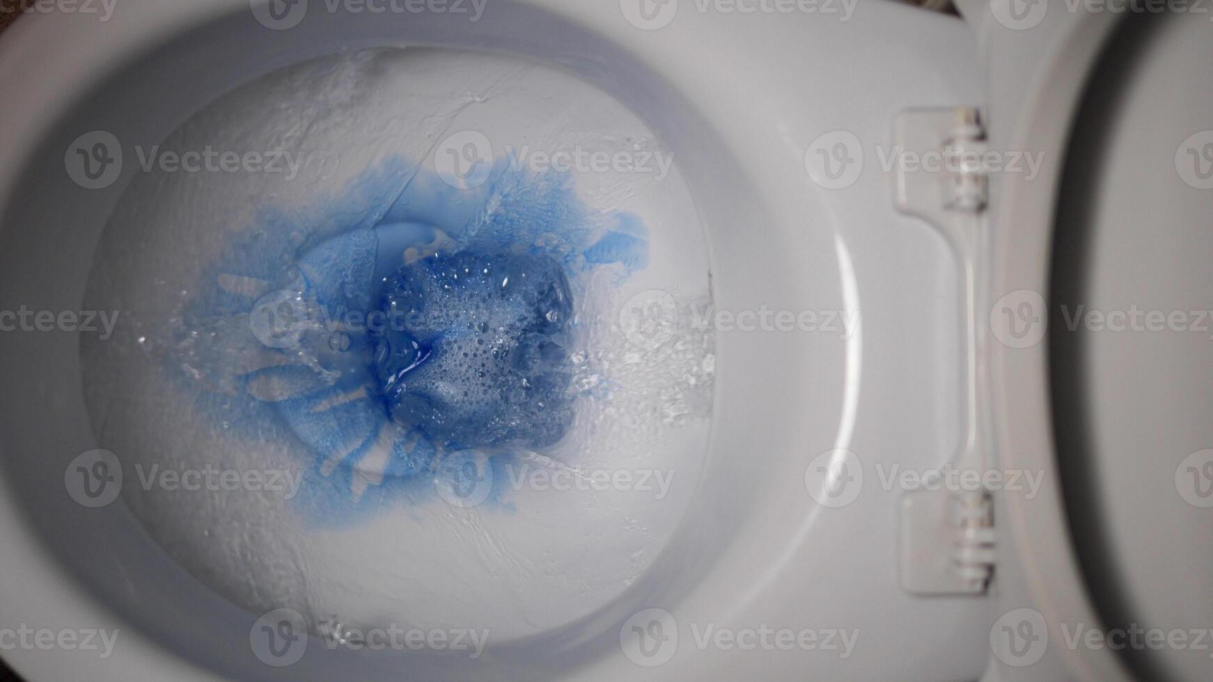 Experience the process of applying blue toilet cleaner into the toilet bowl, promoting germ-free and fresh restroom. Elevate your hygiene standards with this effective sanitation solution photo